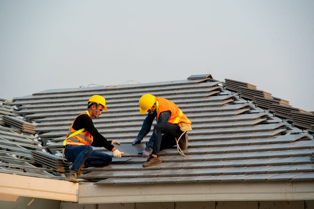 Roofer working on roof structure are installing new roof,Two roofers inspecting new roof.