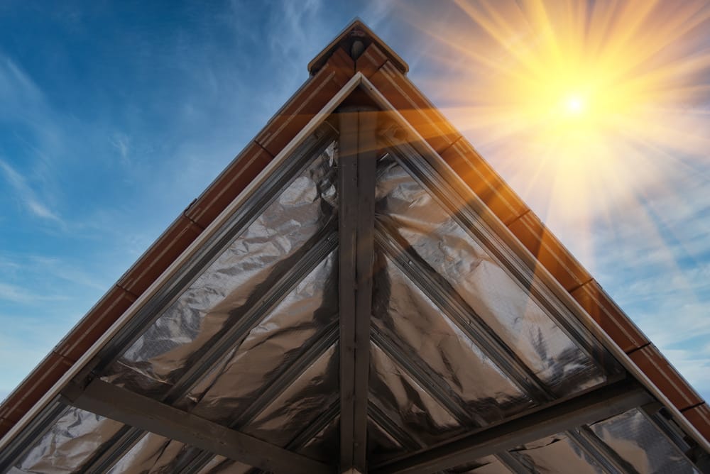 The construction of insulation under the roof of the house Insulating board into roof of house under construction site